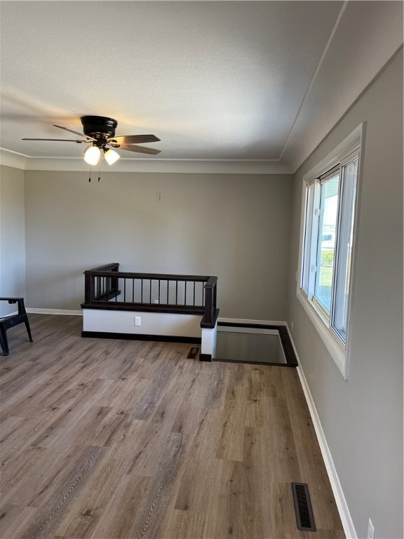 empty room featuring ceiling fan and hardwood / wood-style flooring