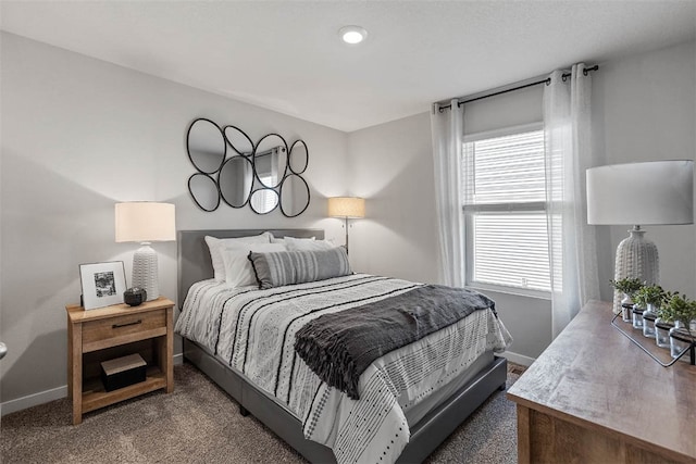 bedroom with dark colored carpet