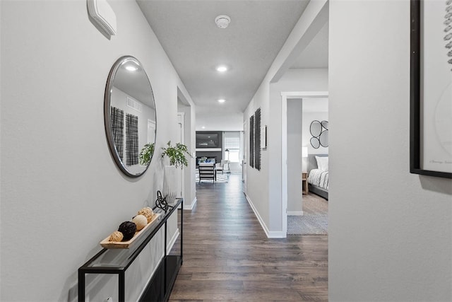 hallway with dark hardwood / wood-style flooring