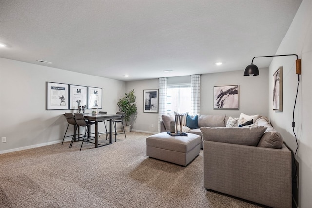 living room featuring carpet flooring and a textured ceiling