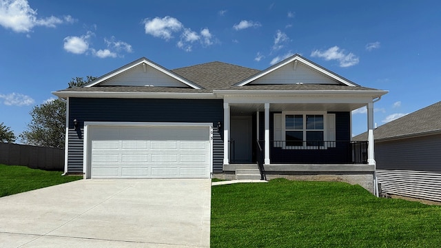 view of front of house with a porch, a garage, and a front lawn