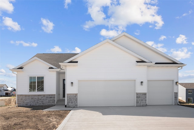 view of front of home featuring central AC unit and a garage