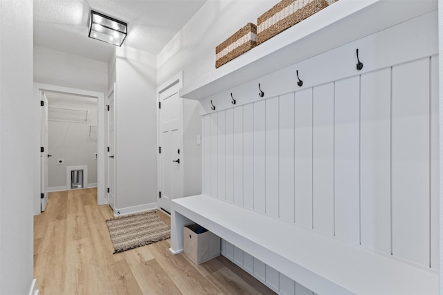 mudroom featuring light hardwood / wood-style floors and a textured ceiling