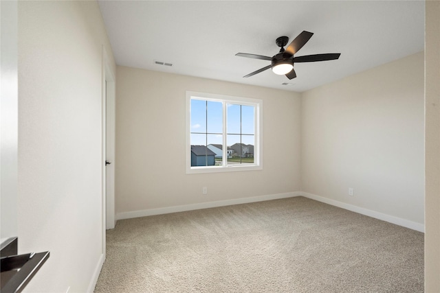 spare room featuring carpet floors and ceiling fan