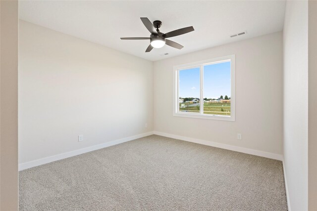 carpeted spare room featuring ceiling fan