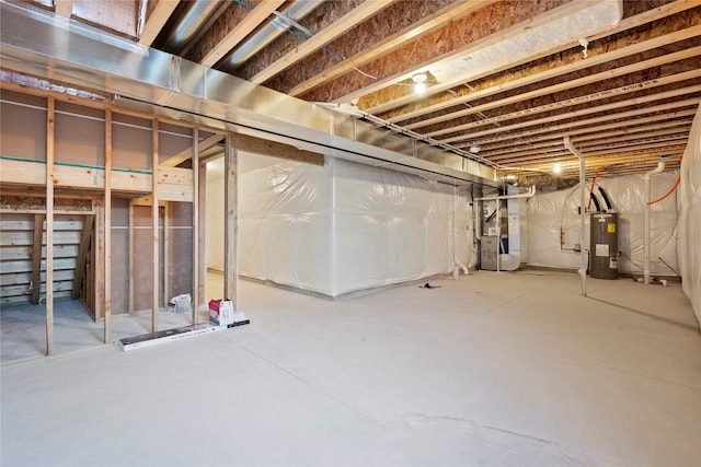 basement featuring heating unit and electric water heater