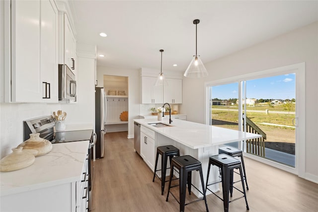 kitchen featuring appliances with stainless steel finishes, sink, and white cabinets