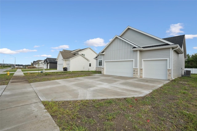 view of front of property with a garage and central air condition unit