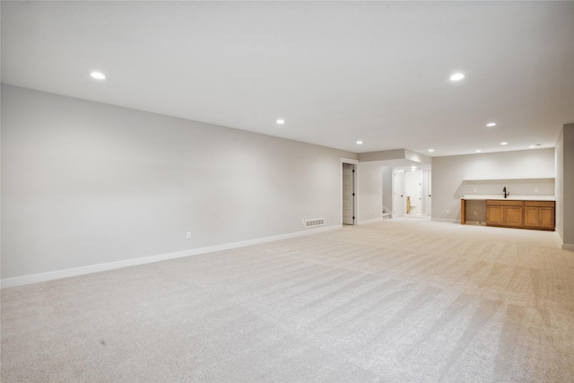 interior space featuring light carpet and sink