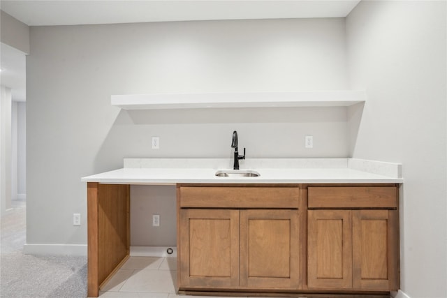 bar featuring sink and light tile patterned floors