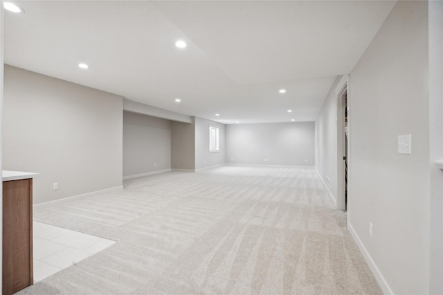 basement featuring light carpet