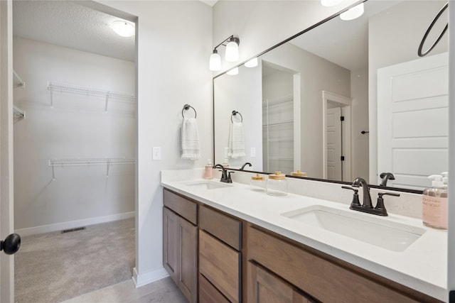 bathroom with vanity and a textured ceiling