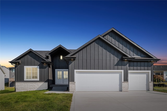 view of front facade with a lawn and a garage