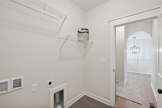 laundry area featuring washer hookup, electric dryer hookup, dark wood-type flooring, and an inviting chandelier