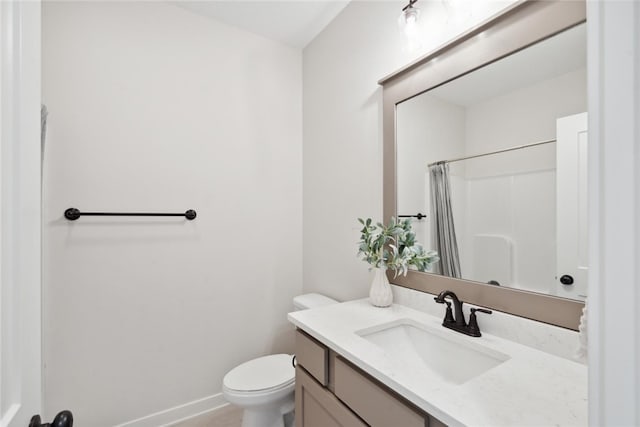 bathroom featuring curtained shower, vanity, and toilet