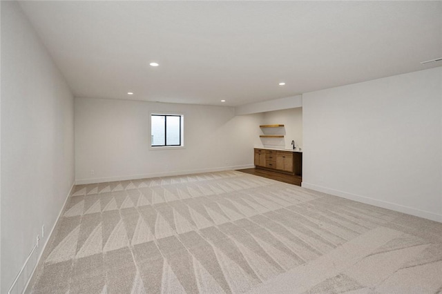 spare room featuring recessed lighting, light carpet, visible vents, and baseboards