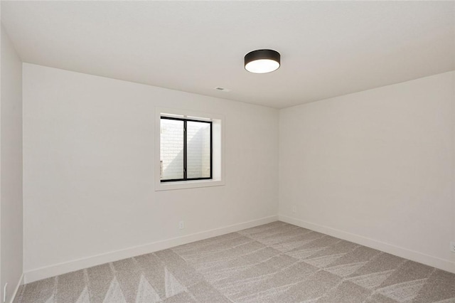 unfurnished room with light carpet, visible vents, and baseboards