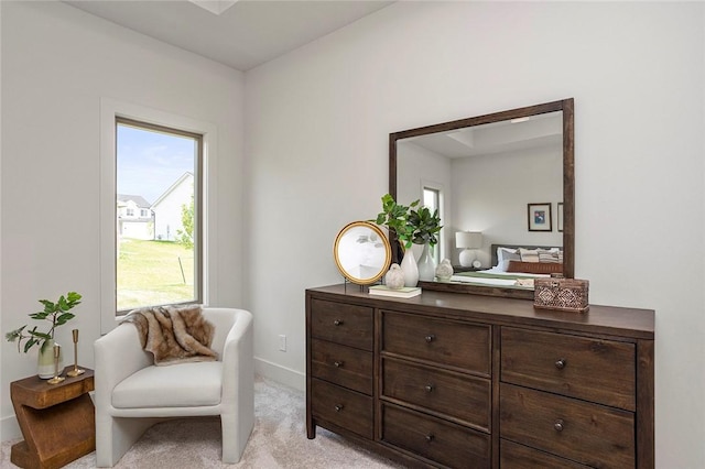 sitting room featuring light colored carpet