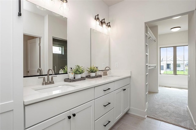 bathroom featuring tile patterned flooring and vanity