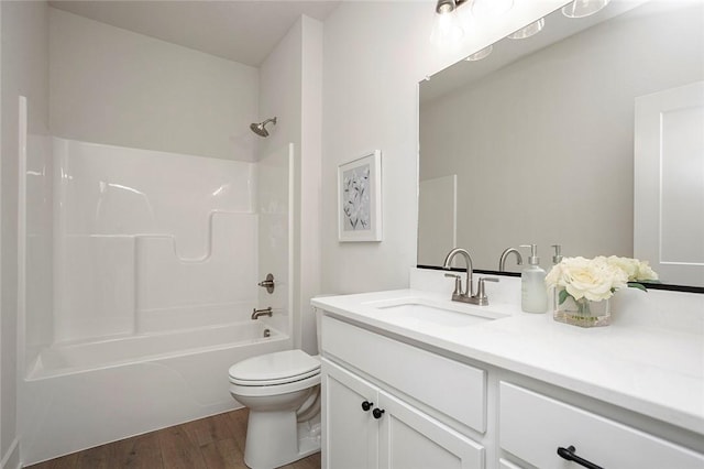 full bathroom featuring bathtub / shower combination, hardwood / wood-style floors, vanity, and toilet