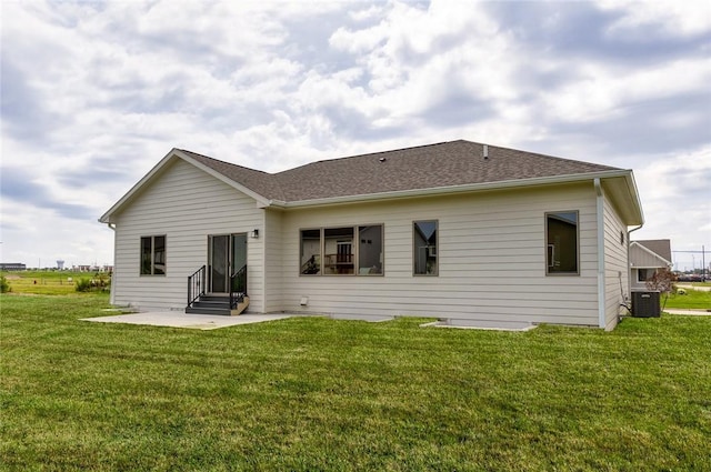 rear view of house featuring cooling unit, a yard, and a patio