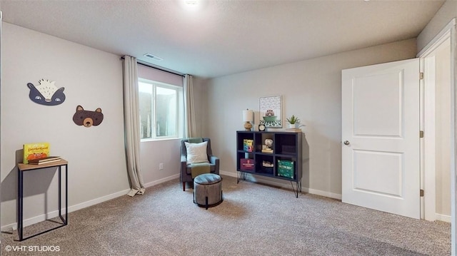 sitting room featuring carpet flooring