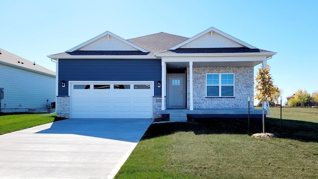 craftsman house featuring a front yard and a garage