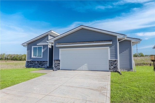 view of front of house featuring a garage and a front lawn