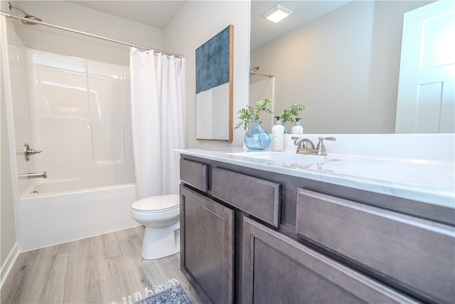 full bathroom featuring toilet, shower / bathtub combination with curtain, wood-type flooring, and vanity