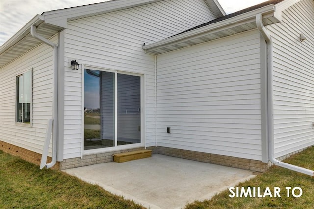 view of side of home with a patio