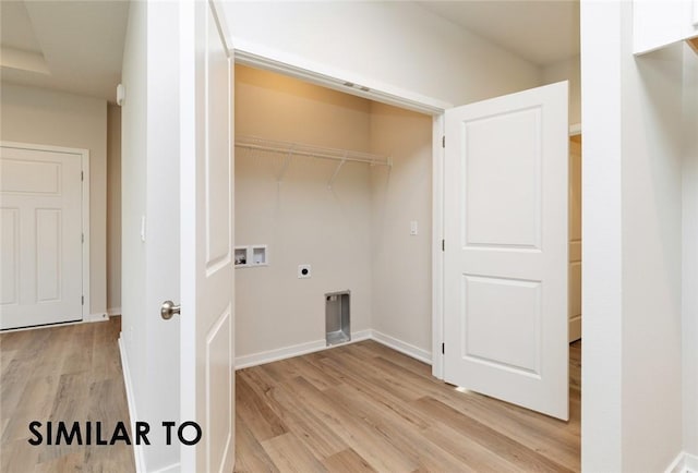 clothes washing area with hookup for a washing machine, hookup for an electric dryer, and light hardwood / wood-style flooring