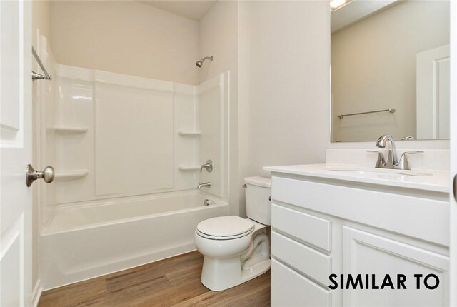 full bathroom with vanity, toilet, wood-type flooring, and washtub / shower combination