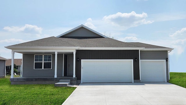 view of front of home featuring a front yard and a garage