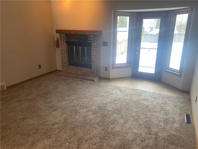 unfurnished living room with a fireplace and light colored carpet