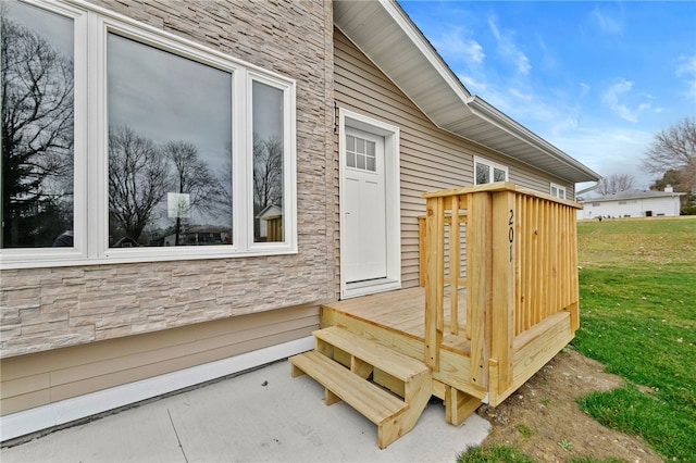 wooden terrace featuring a yard