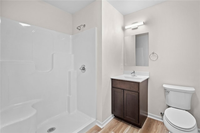 bathroom with vanity, toilet, wood-type flooring, and walk in shower