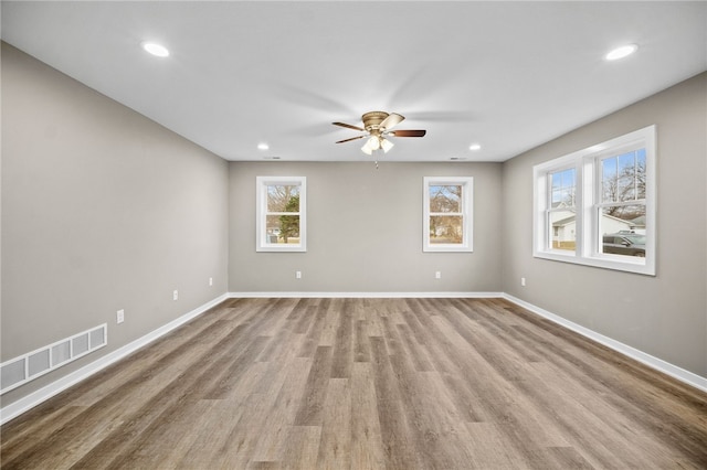 empty room with light wood-type flooring and ceiling fan