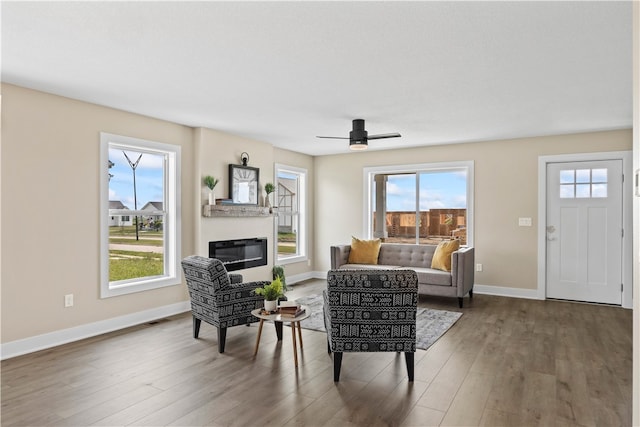 living room with hardwood / wood-style flooring, plenty of natural light, and ceiling fan