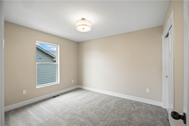 unfurnished bedroom featuring carpet floors, visible vents, baseboards, and a closet