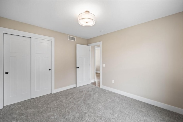 unfurnished bedroom featuring a closet and carpet flooring