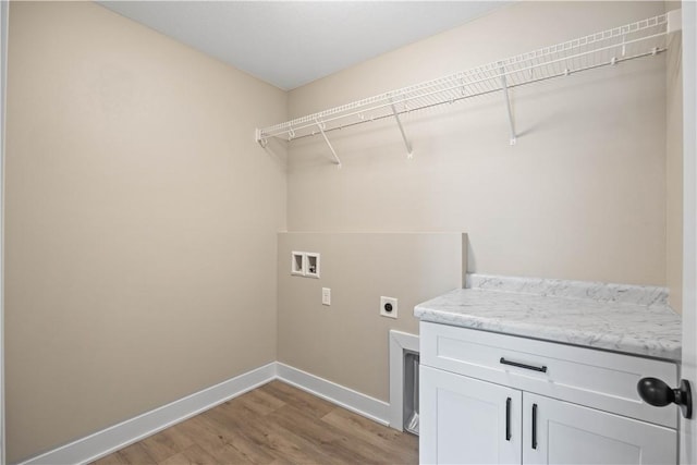 laundry area featuring cabinets, wood-type flooring, electric dryer hookup, and washer hookup