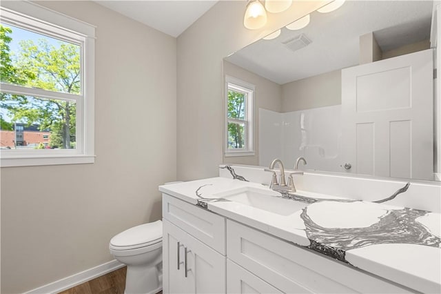 full bathroom with a wealth of natural light, visible vents, toilet, and walk in shower