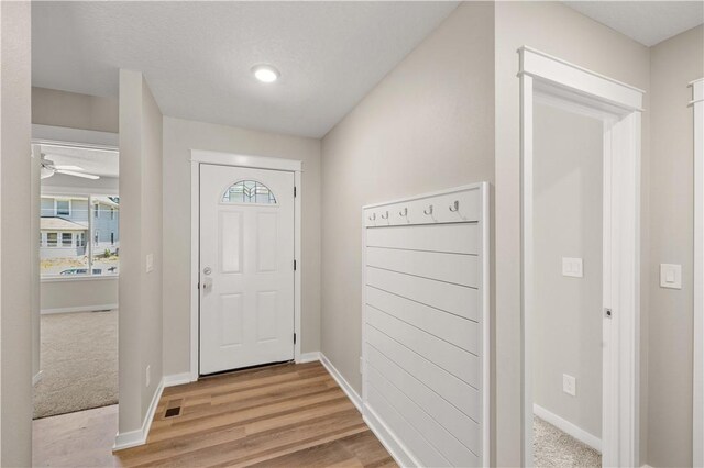 foyer entrance featuring ceiling fan and light hardwood / wood-style floors