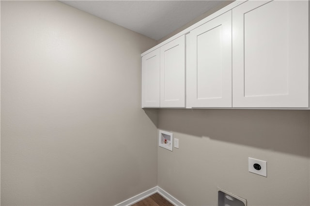 washroom with hookup for an electric dryer, washer hookup, hardwood / wood-style flooring, and cabinets