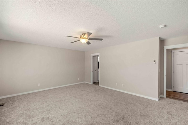 unfurnished room with a textured ceiling, baseboards, a ceiling fan, and light colored carpet