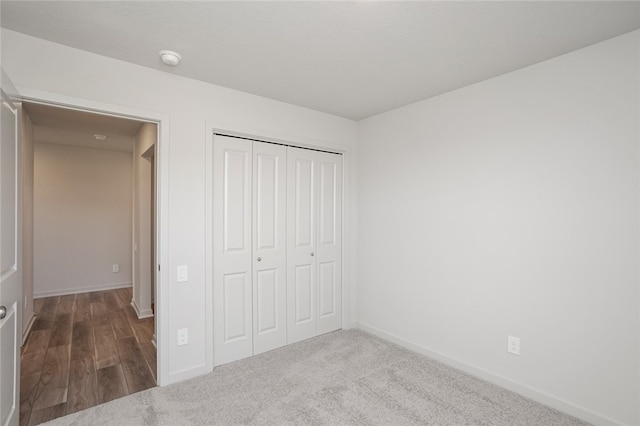 unfurnished bedroom featuring carpet and a closet