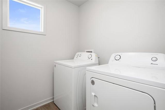 laundry room with independent washer and dryer and wood-type flooring