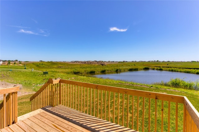 wooden terrace featuring a yard, a water view, and a rural view