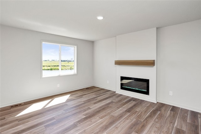 unfurnished living room with light hardwood / wood-style floors