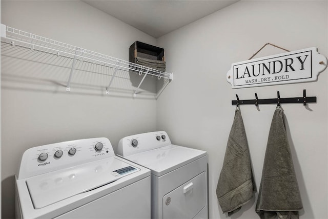 clothes washing area with separate washer and dryer